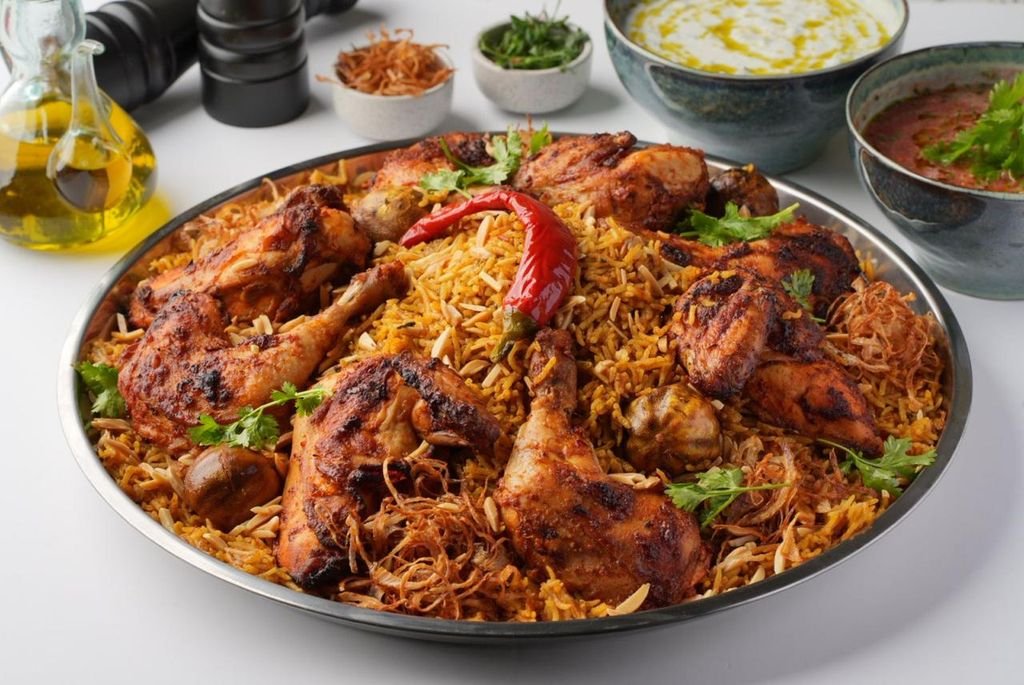 Golden roasted chicken and aromatic kabsa rice, generously arranged on a large sharing platter