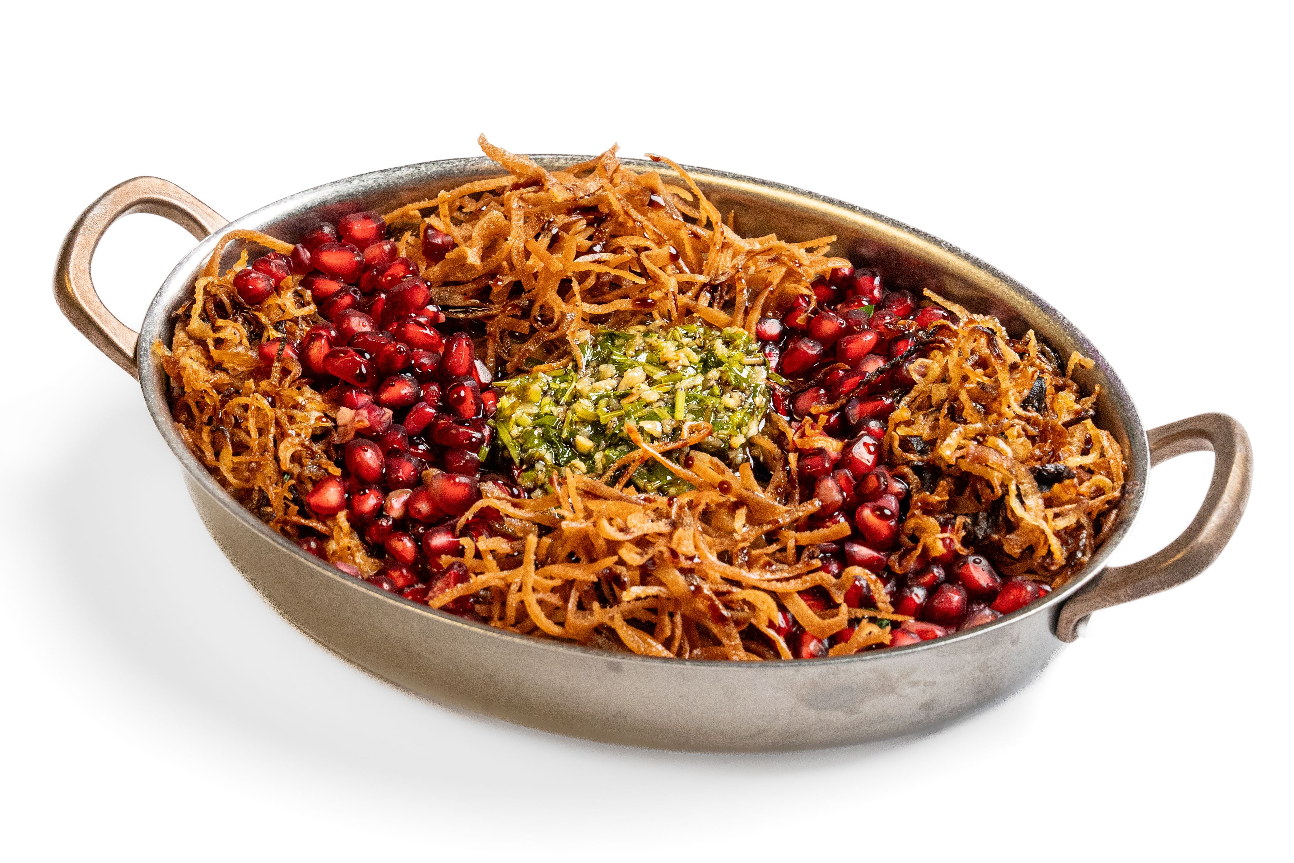 A handled platter topped with pomegranate, crisp strips and chopped herbs