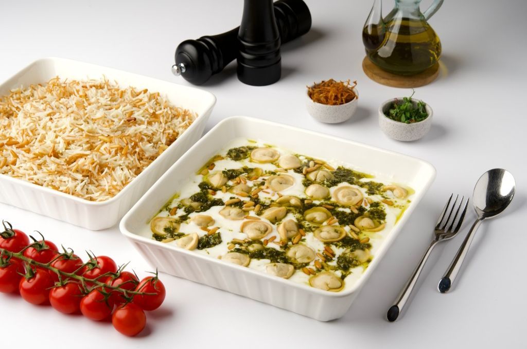 Lamb-filled shish barak dumplings in yogurt sauce, with herbs and vermicelli rice alongside